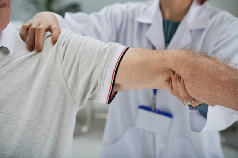 Physiotherapist assessing a shoulder injury